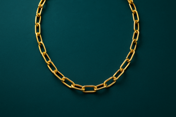 14K gold paperclip chain necklace teal background